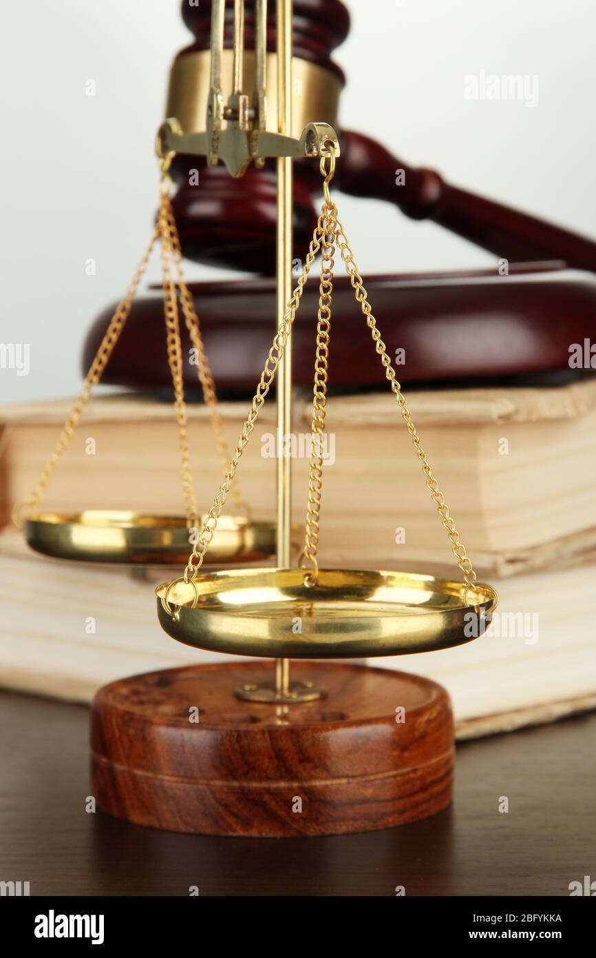 Golden scales of justice, gavel and books on grey background Stock ...