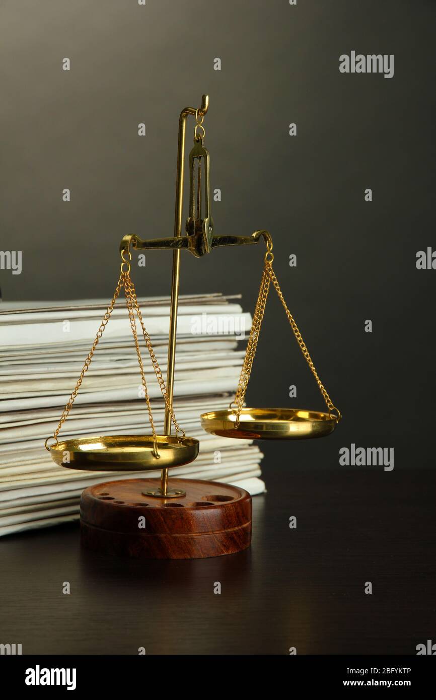 Gold scales of justice and folders on grey background Stock Photo - Alamy