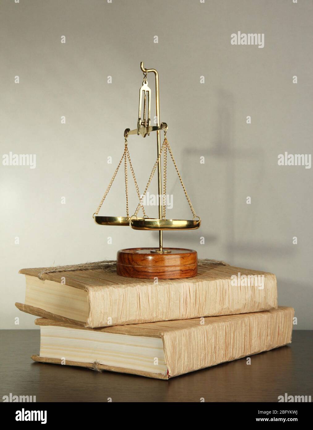 Gold scales of justice and books on grey background Stock Photo - Alamy