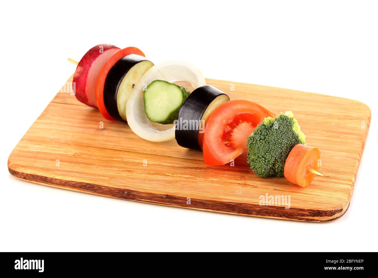 Sliced vegetables on wooden pick isolated on white Stock Photo