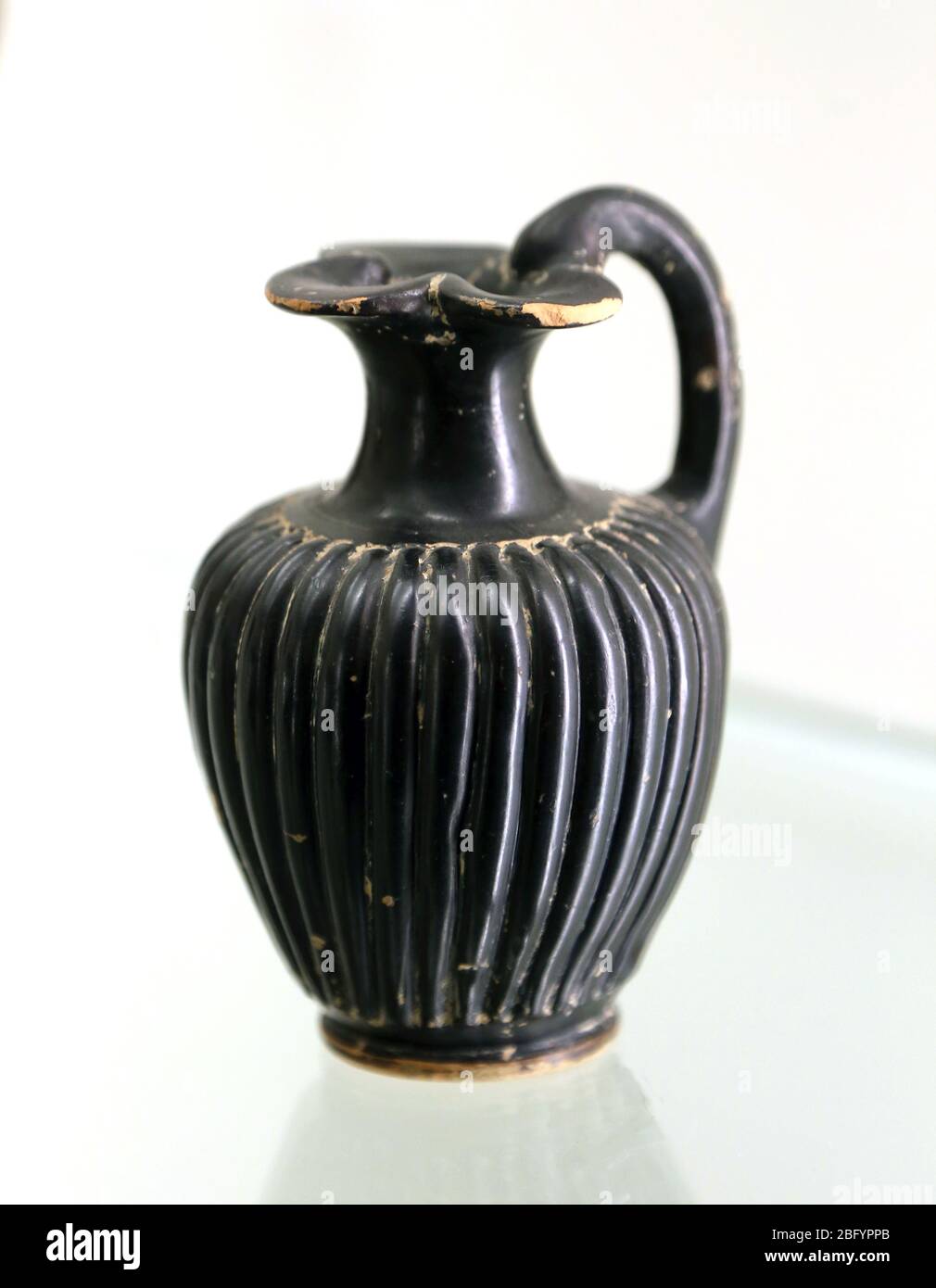 Black glazed oinochoe (vessel) gently ribbed.  Attic pottery, 4th century BC. Emporion. Archaeology Museum of Catalonia. Barcelona. Stock Photo