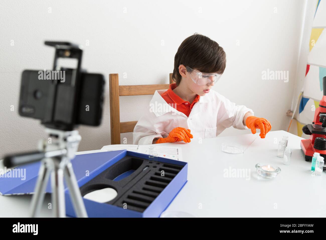 9 year old boy makes educational video about chemical experiments for his vlog Stock Photo
