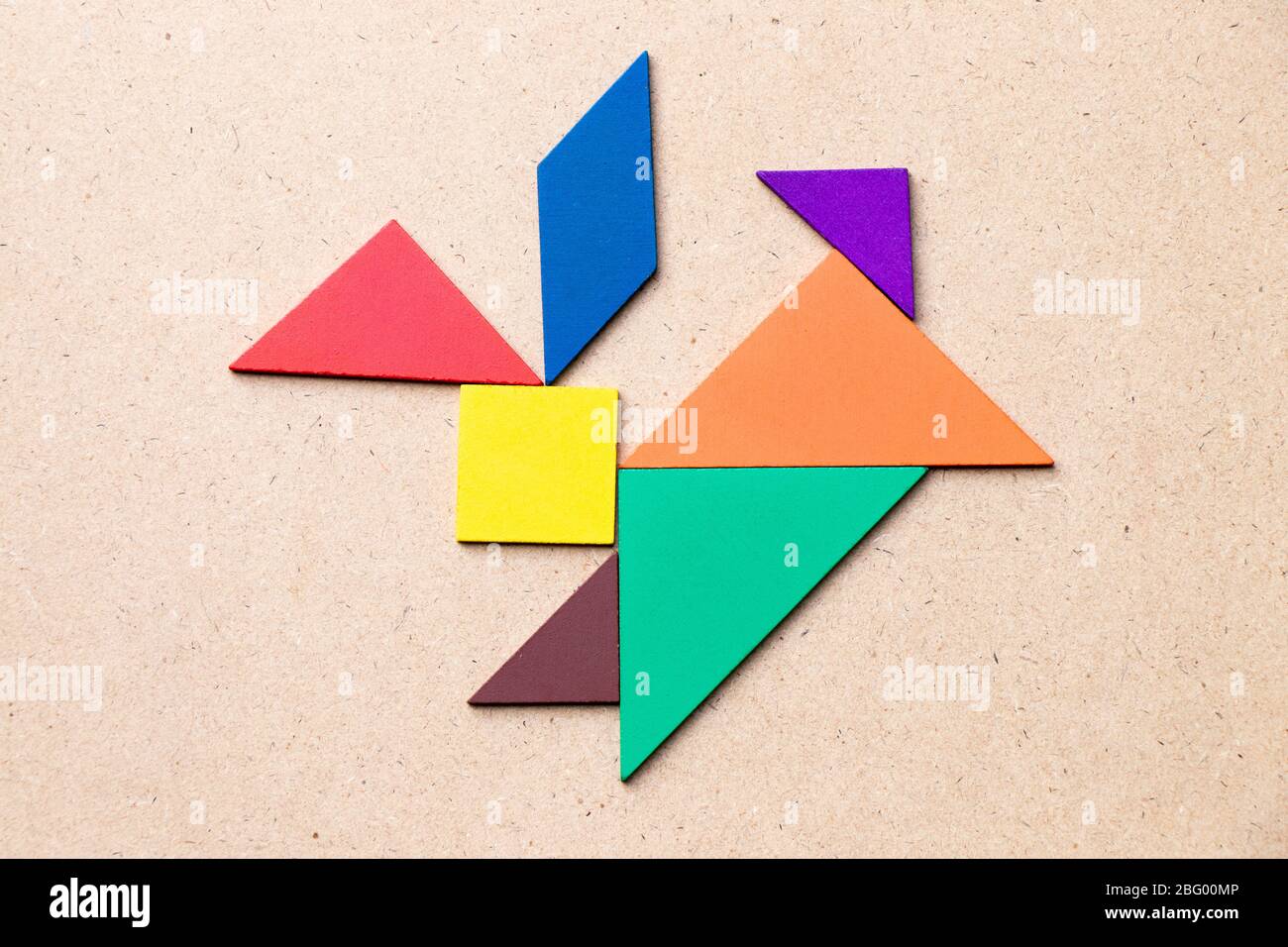 Color tangram in rabbit shape on wood background Stock Photo - Alamy