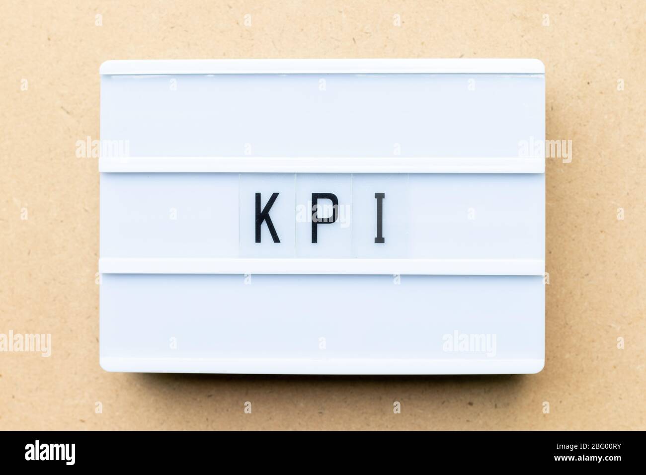 White lightbox with word KPI (Abbreviation of key performance indicator) on wood background Stock Photo