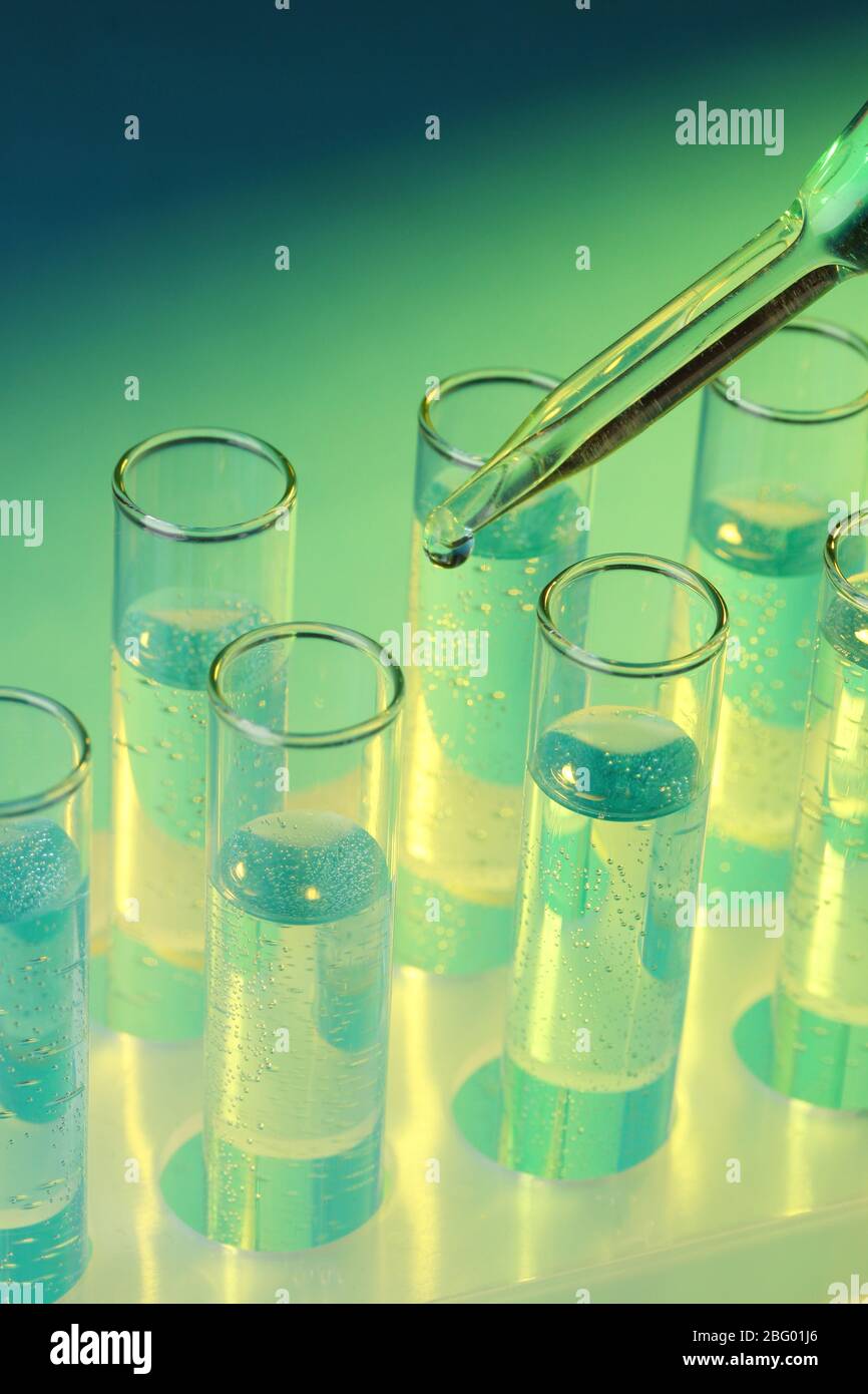 test-tubes with liquid on blue background Stock Photo - Alamy