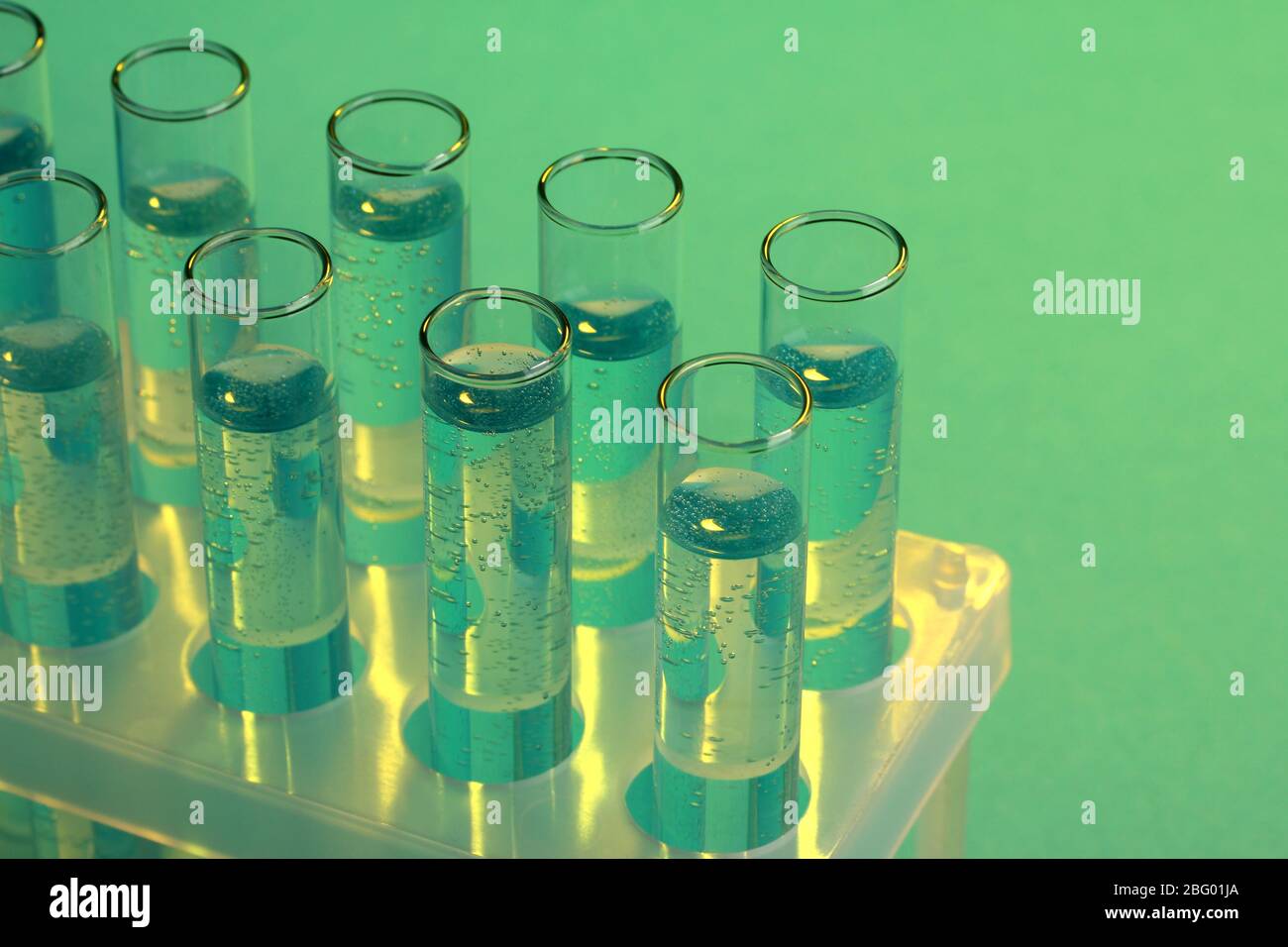test-tubes with liquid on blue background Stock Photo - Alamy