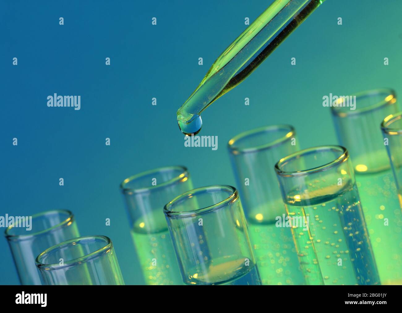 test-tubes with liquid on blue background Stock Photo - Alamy