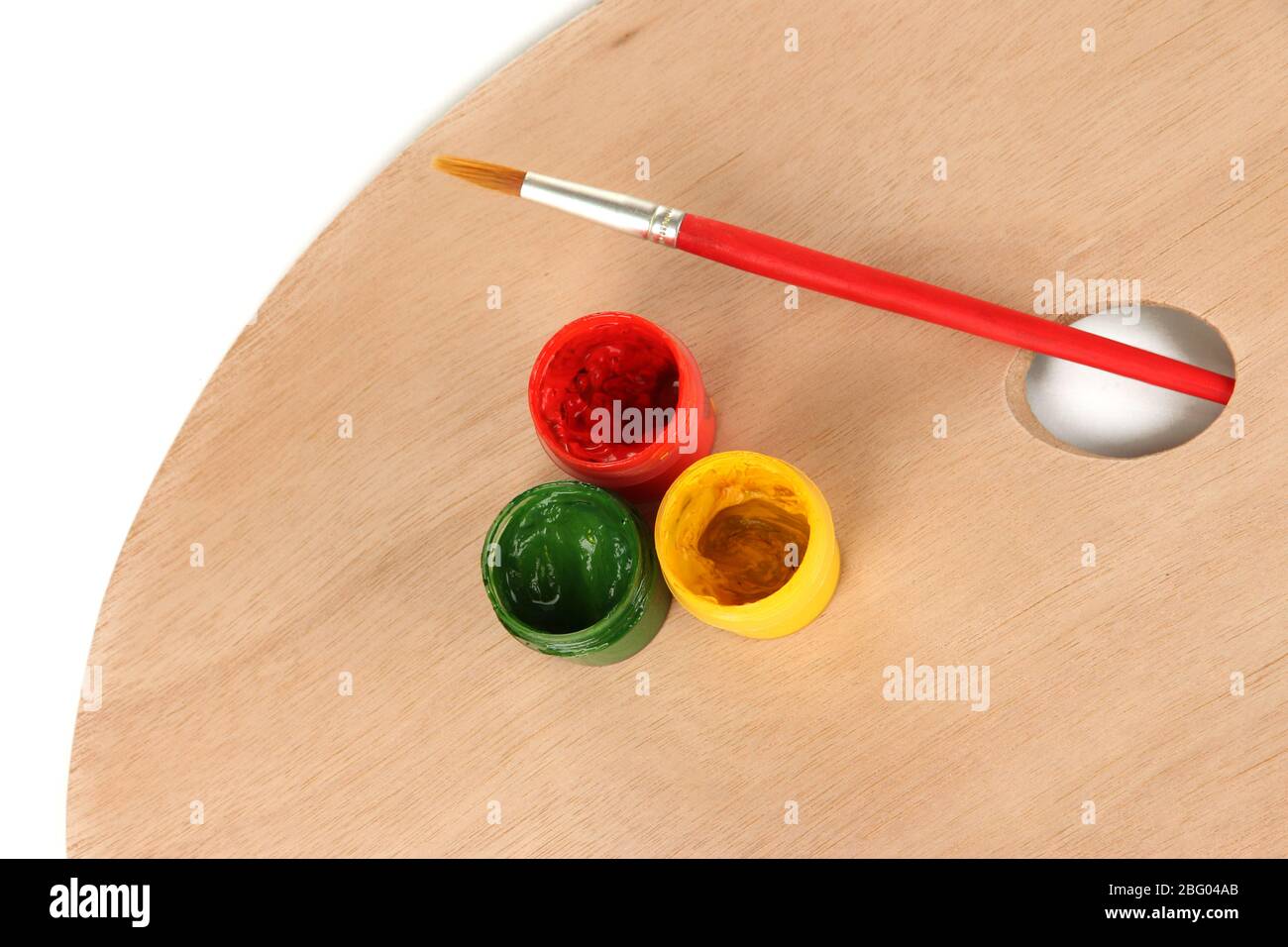 Wooden art palette with brush for painting and paints isolated on white ...