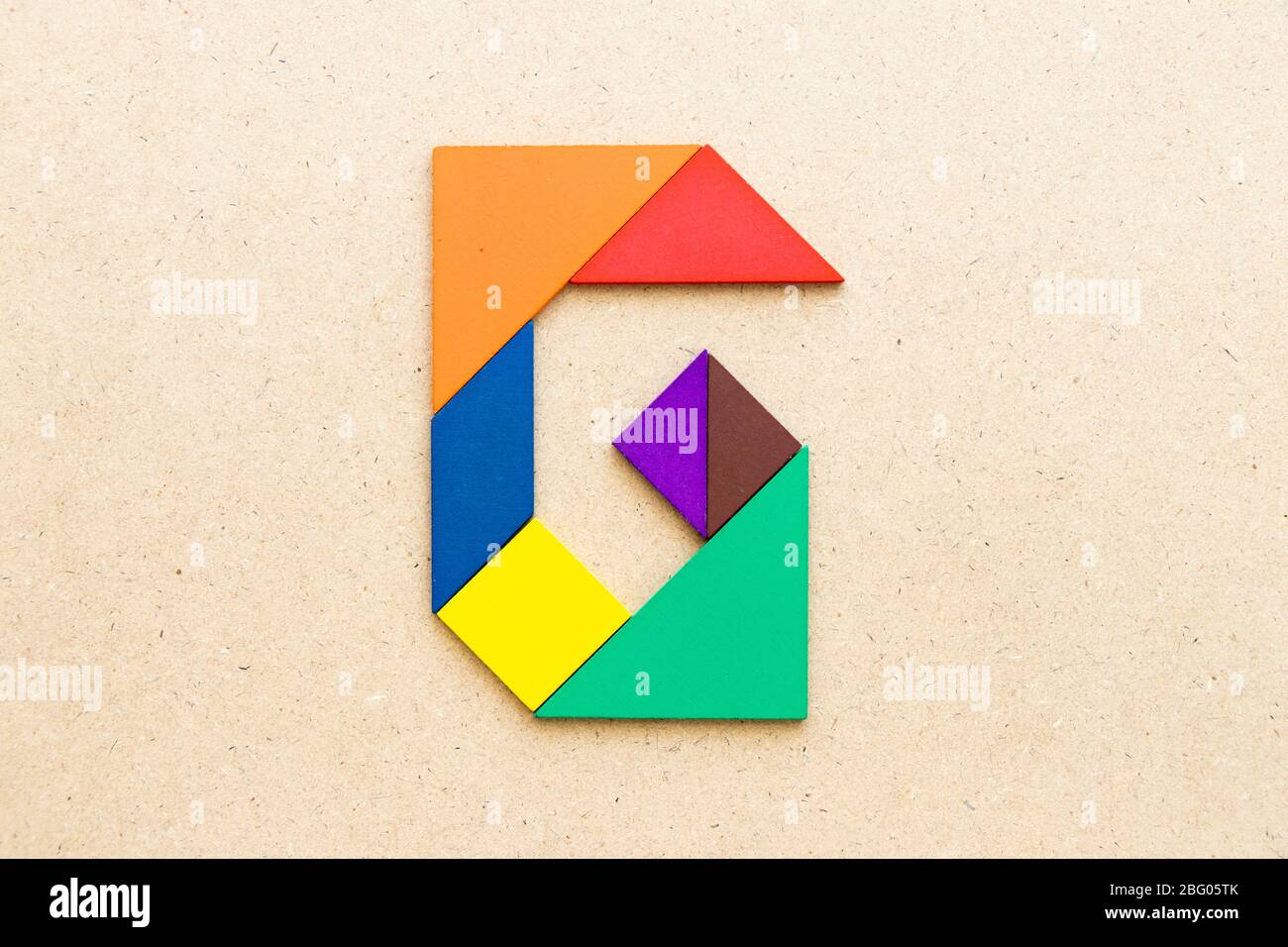 Tangram puzzle in alphabet letter G shape on wood background Stock Photo -  Alamy