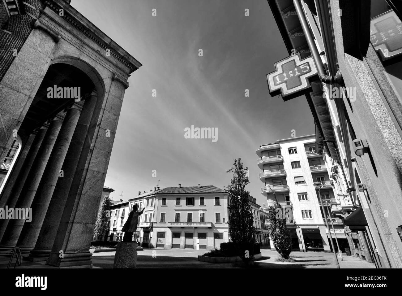 The silence and the desolation in a city near Milan, in sunday morning, during Coronavirus.The main church place is empty no people. Stock Photo
