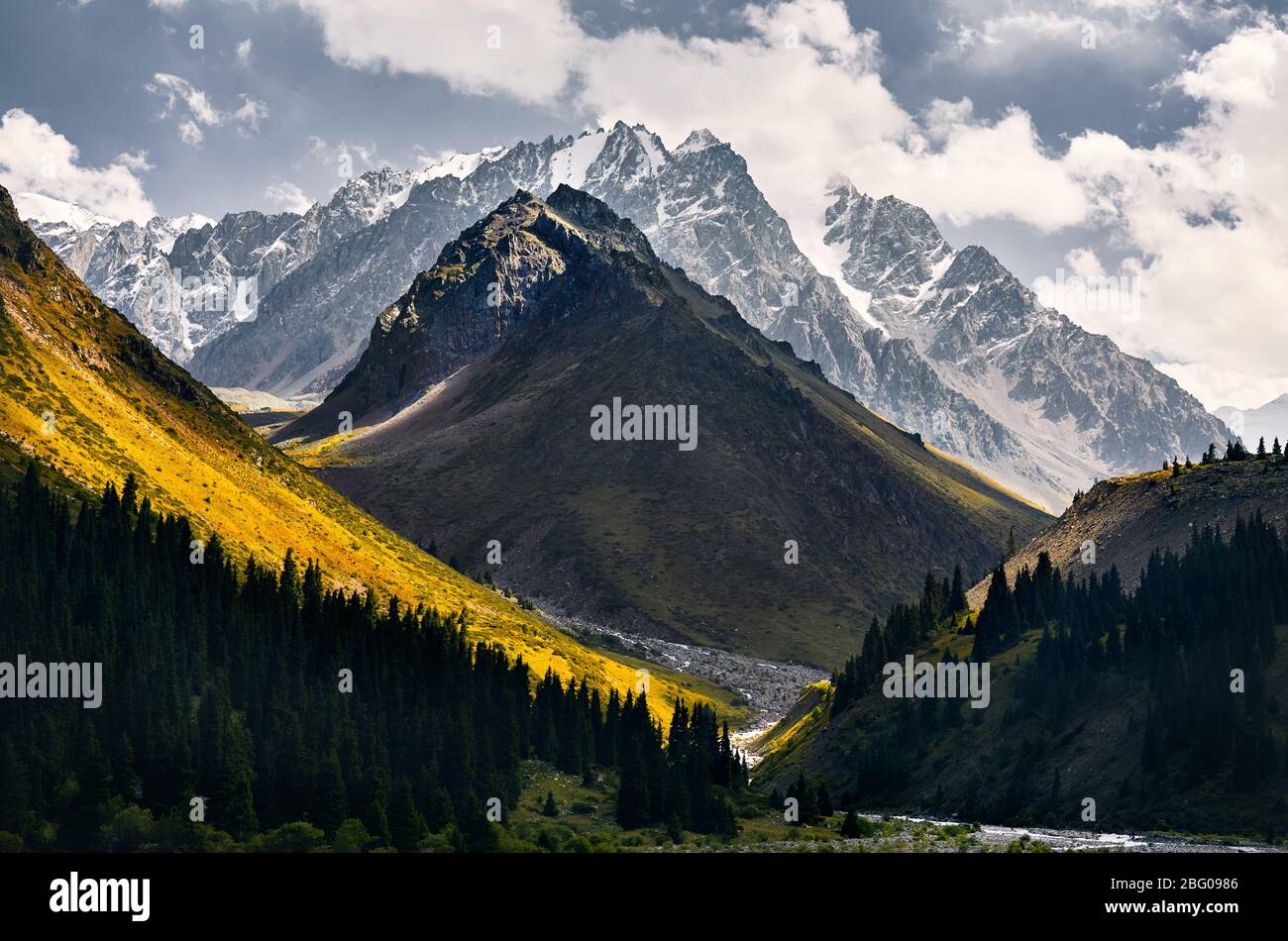 Beautiful landscape of snowy mountains in green valley of Left Talgar in Kazakhstan, Central Asia Stock Photo