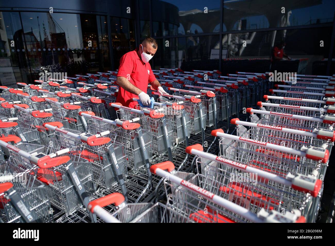 Pulheim Germany th Apr An Employee Disinfects Shopping Trolleys In Front Of Segmuller Furniture Store