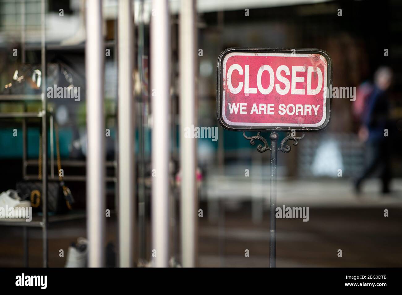 Nuremberg, Germany. 20th Apr, 2020. 'Closed - We are sorry' is written on a sign behind the door of a store downtown. From 20 April, for the first time since the ordered closure in the Corona crisis, certain shops are allowed to reopen. However, it will not be possible to shop in all federal states at the start of the week. In Bavaria, Berlin, Thuringia and Brandenburg, shops may only open later. Credit: Daniel Karmann/dpa/Alamy Live News Stock Photo