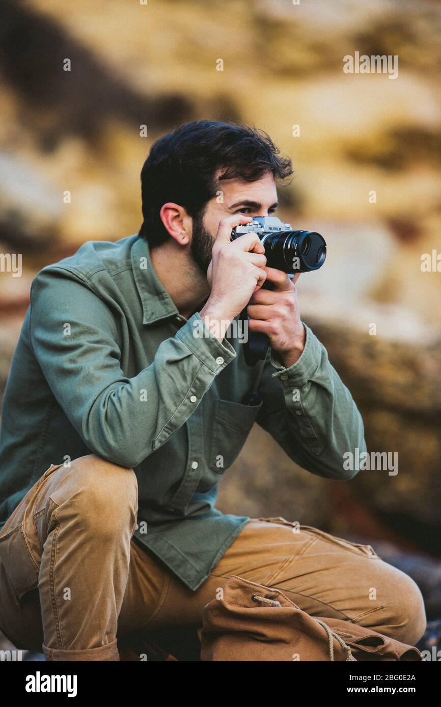 Portrait of young Man taking pictures outdoors Stock Photo