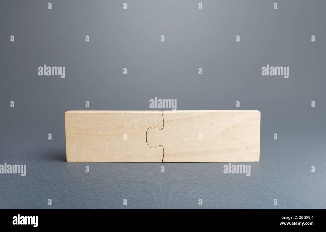 Two connected puzzles. Concept of integrity and completeness. Arrangement and deal contract. Task completion, successful completion. Simplicity and re Stock Photo