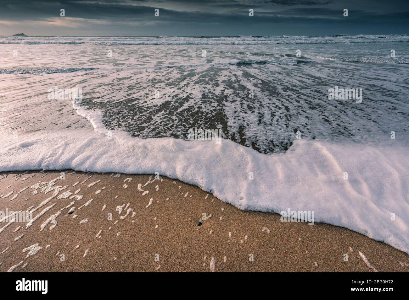 A receding ebb tide on a cold chilly evening at Fistral Beach in Newquay in Cornwall. Stock Photo