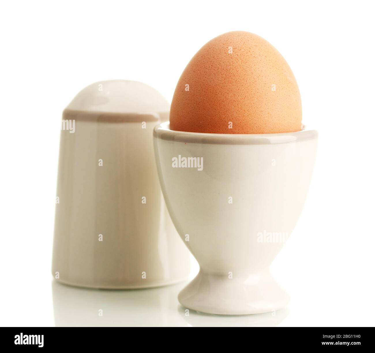 Whole boiled egg in egg cup and salt, isolated on white Stock Photo Alamy