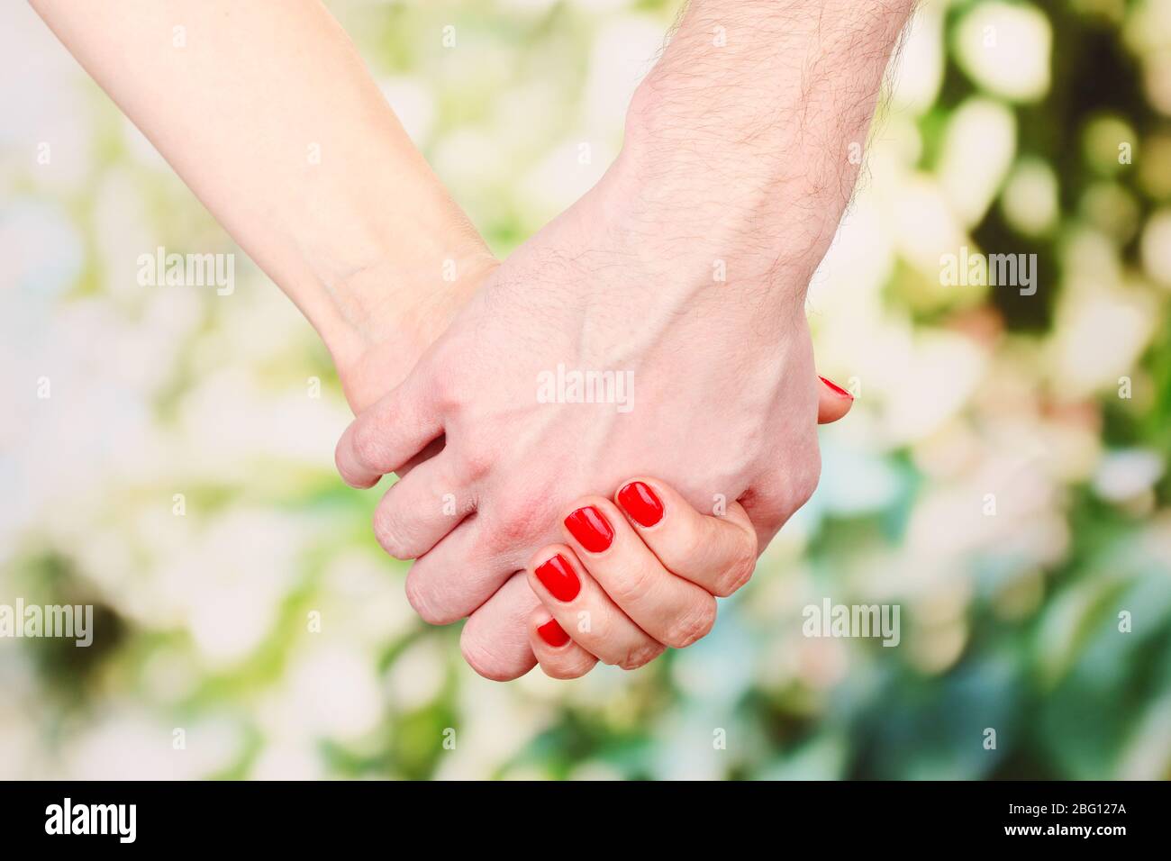 Two hands over green nature park Stock Photo - Alamy