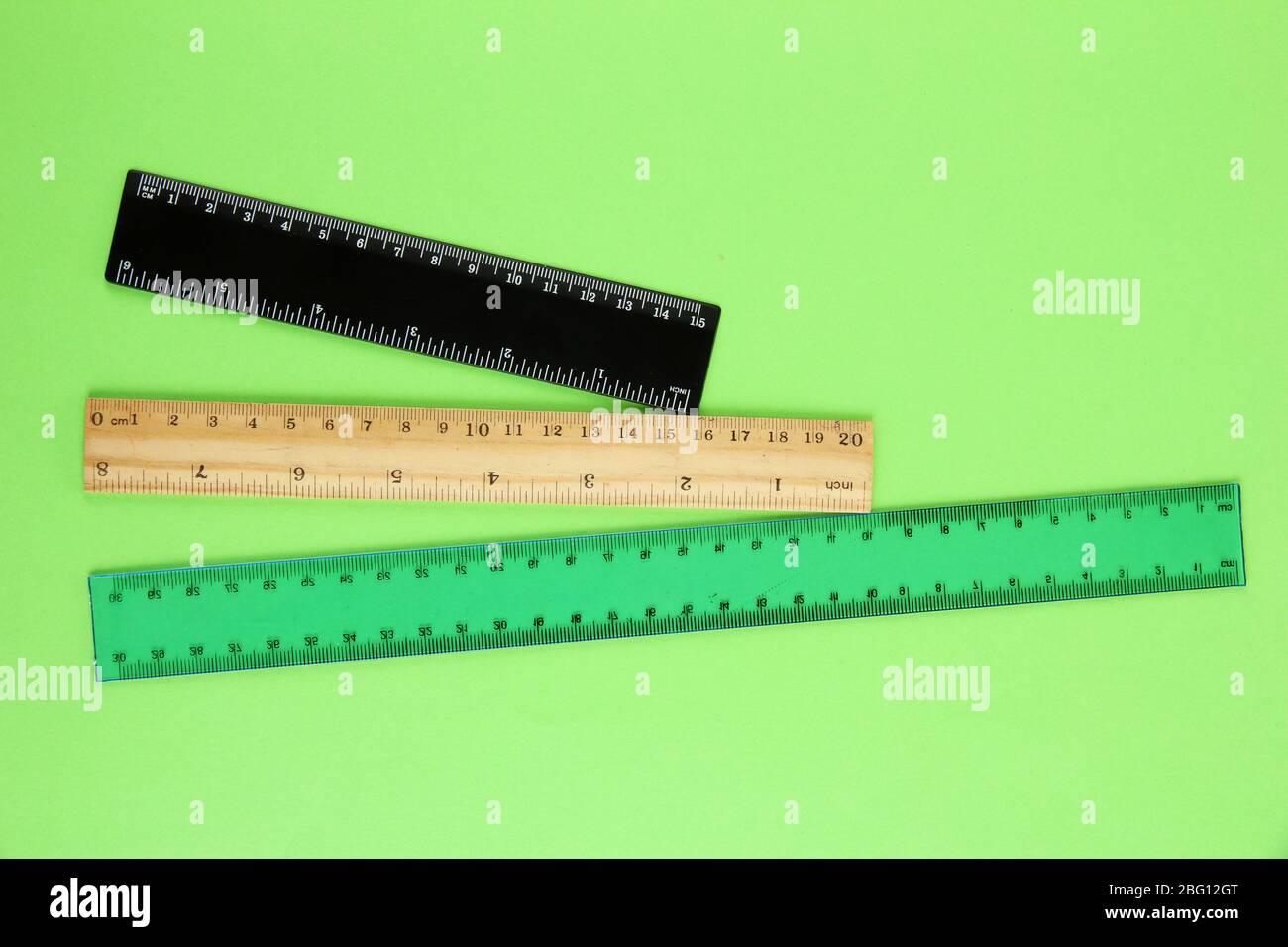 Rulers on green background Stock Photo