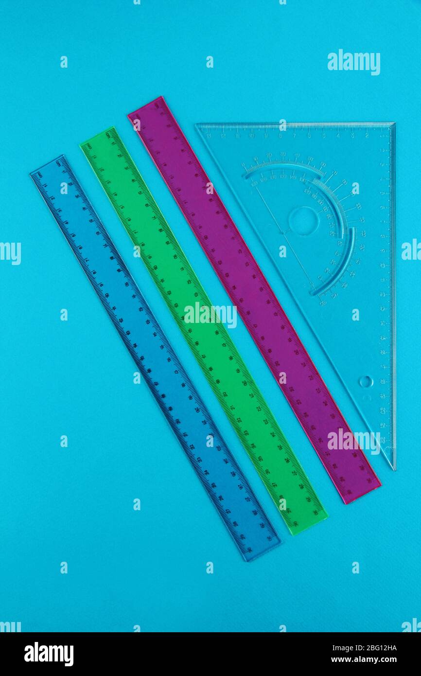 Rulers on blue background Stock Photo