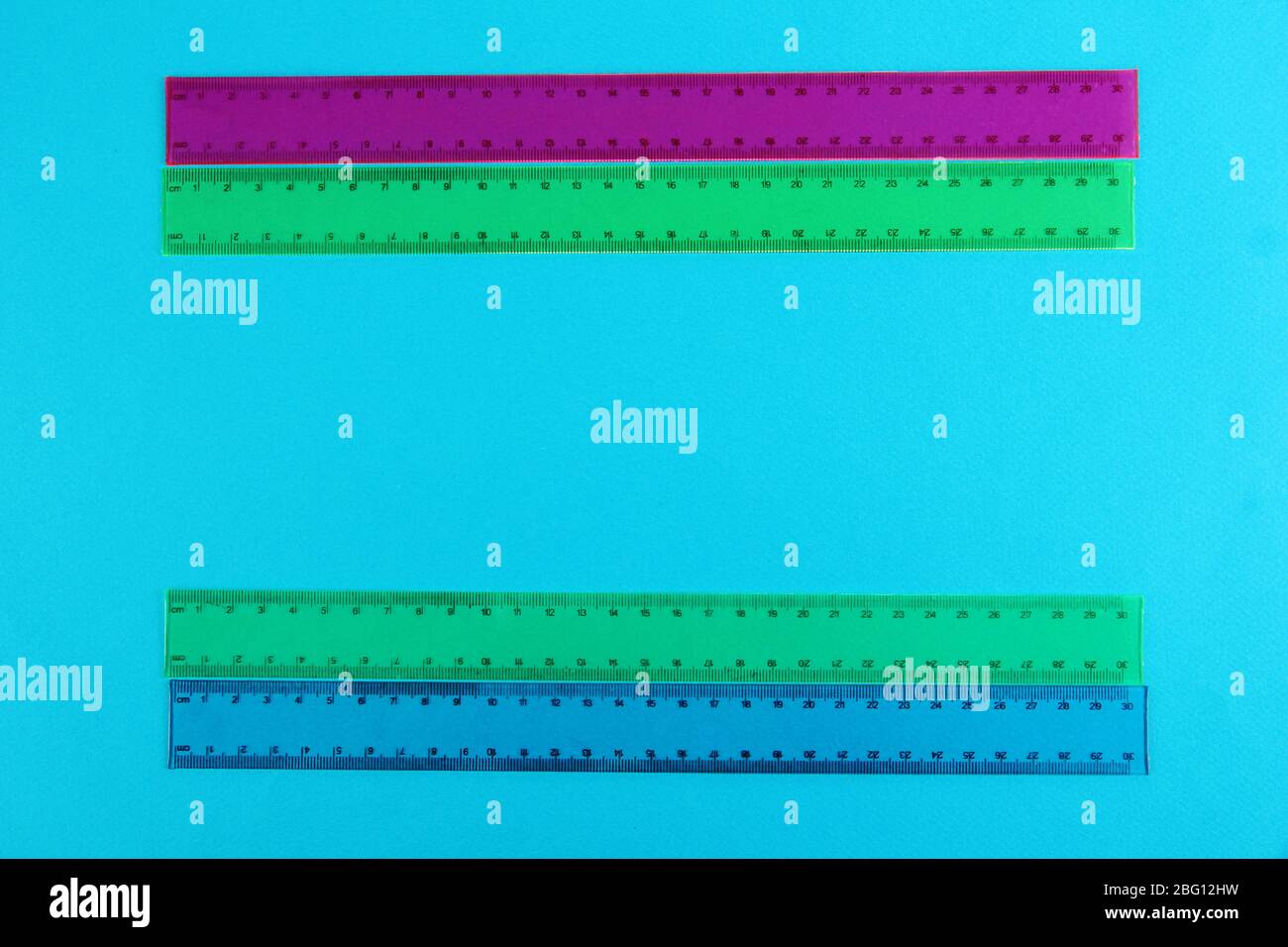 Rulers on blue background Stock Photo