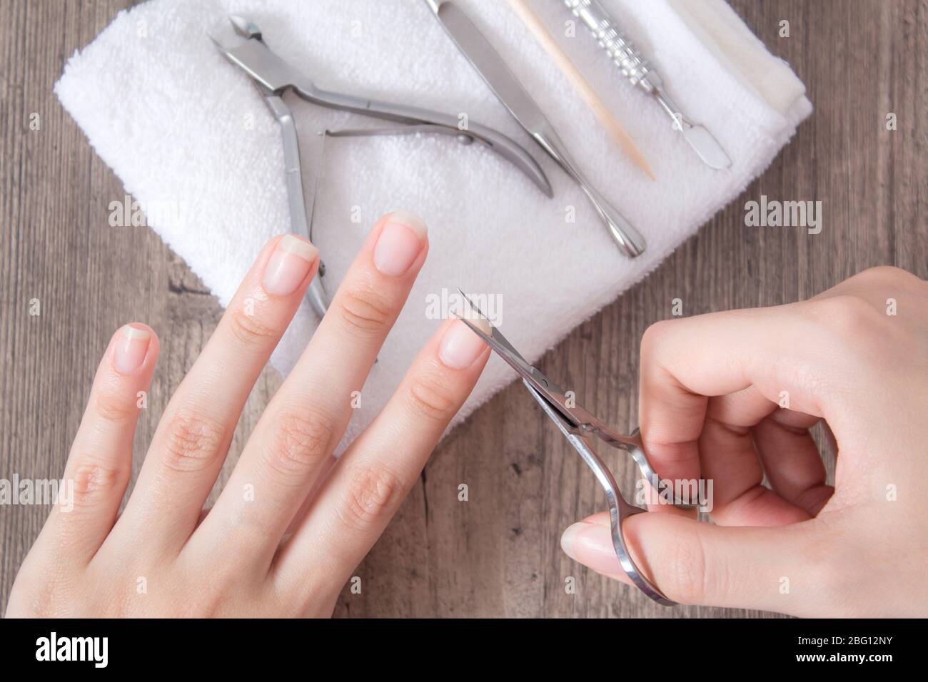 Trim the nails on the hand. Do yourself a manicure. Shorten long nails