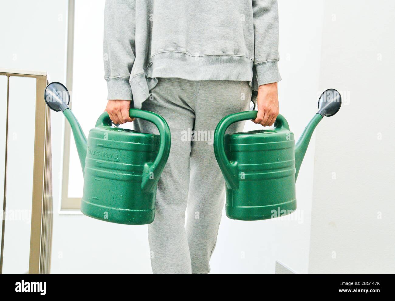 Pfaffenhofen a.d.Ilm, Germany, April 20, 2020. Woman with watering can watering flowers and plants on April 20, 2020 in Pfaffenhofen a.d.Ilm, Bavaria, Germany. Model released © Peter Schatz / Alamy Live News Stock Photo