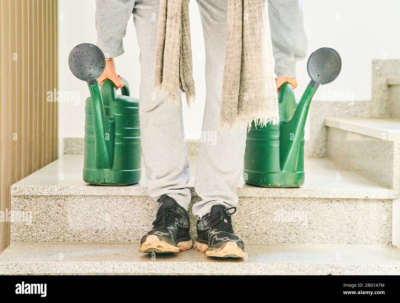 Pfaffenhofen a.d.Ilm, Germany, April 20, 2020. Woman with watering can watering flowers and plants on April 20, 2020 in Pfaffenhofen a.d.Ilm, Bavaria, Germany. Model released © Peter Schatz / Alamy Live News Stock Photo