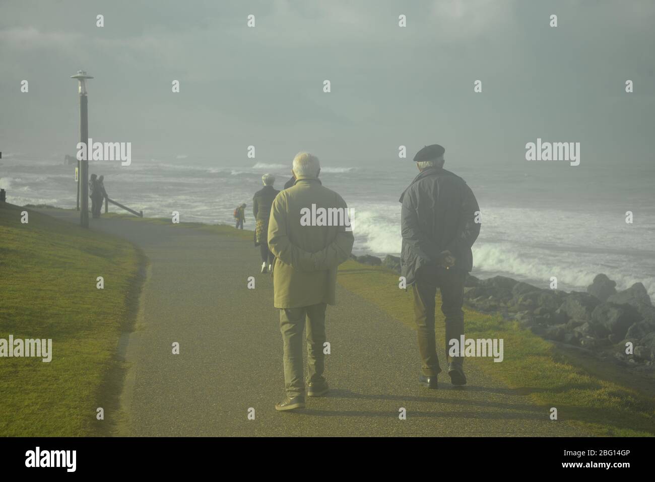 Two elderly men strolling along the Basque Coast in France, pasakdek Stock Photo