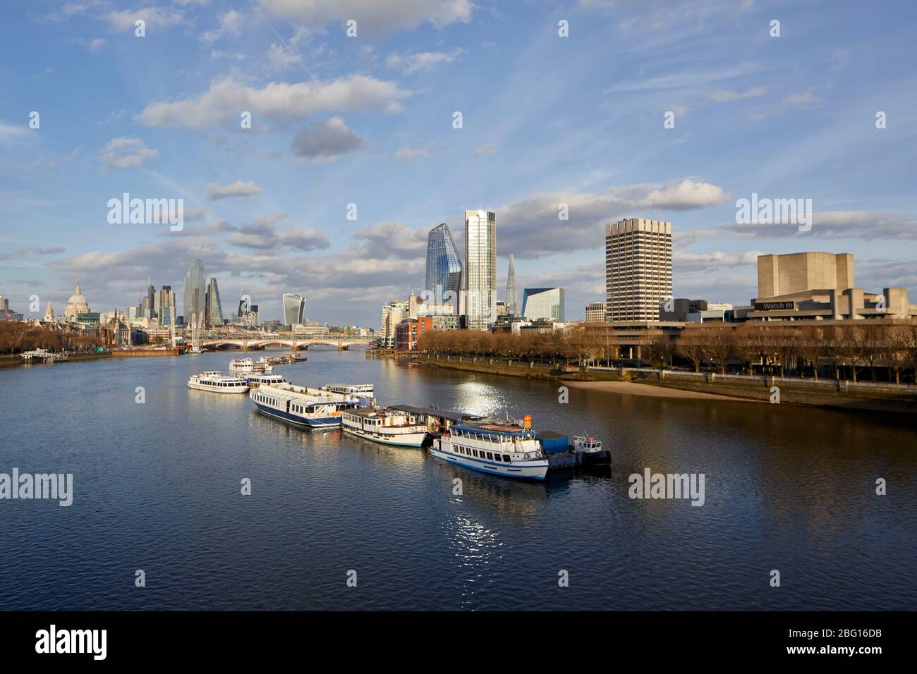 Springtime view of River Thames with the City of London and moored pleasure boats during restricted travel of Coronavirus COVID-19 Lockdown in London Stock Photo