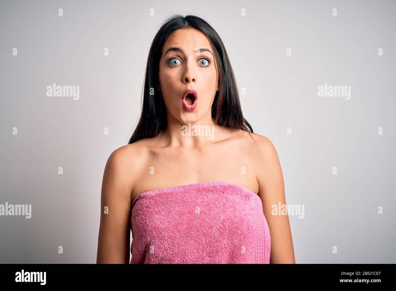 Young woman with blue eyes wearing shower towel after bath