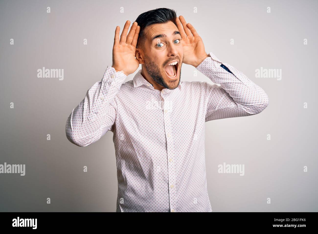 young-handsome-man-wearing-elegant-shirt-standing-over-isolated-white