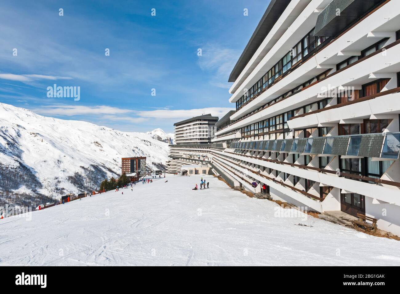 Large hotel on mountain piste ski slope with balcony in alpine ski resort Stock Photo