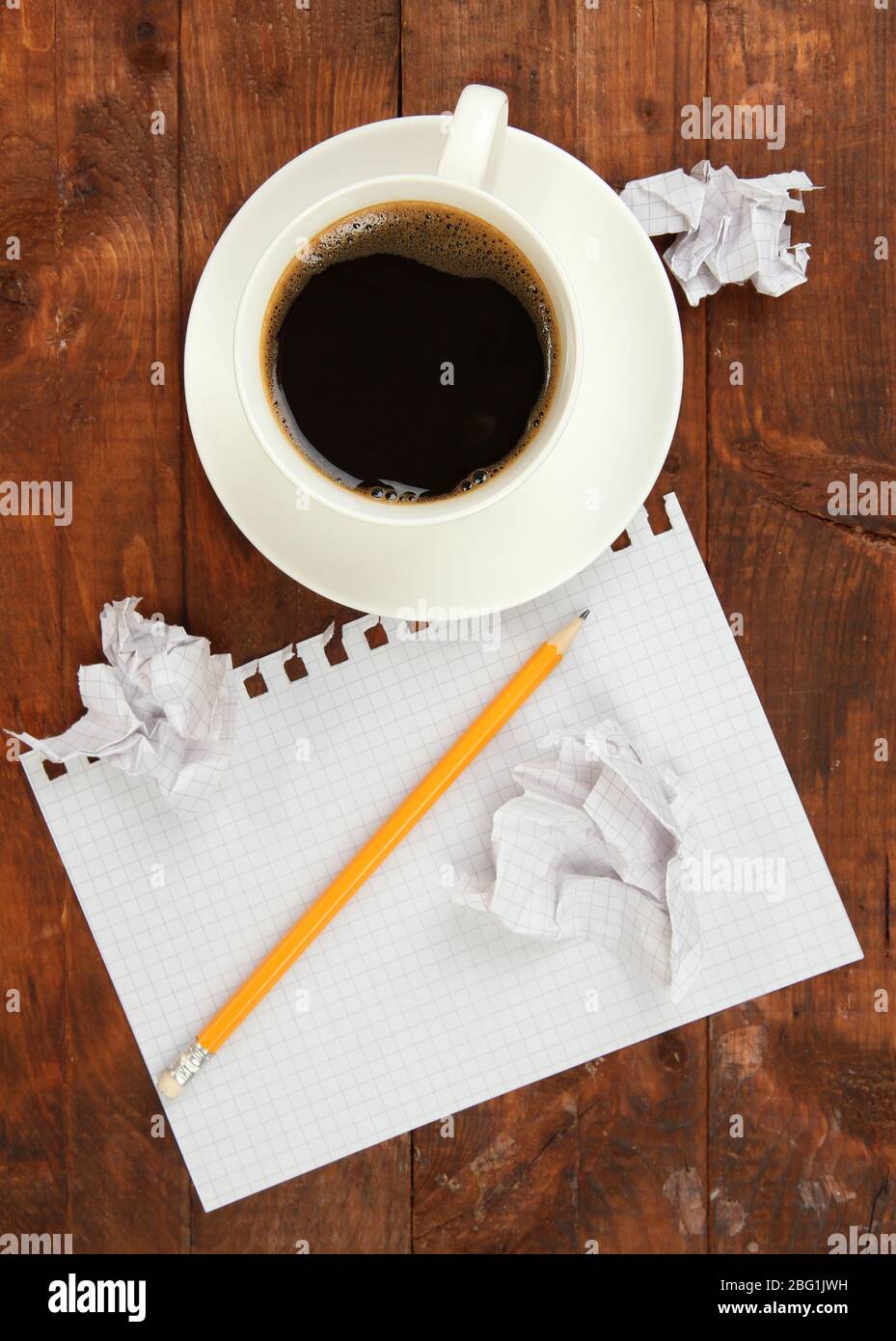 Cup of coffee on worktable covered with documents close up Stock Photo