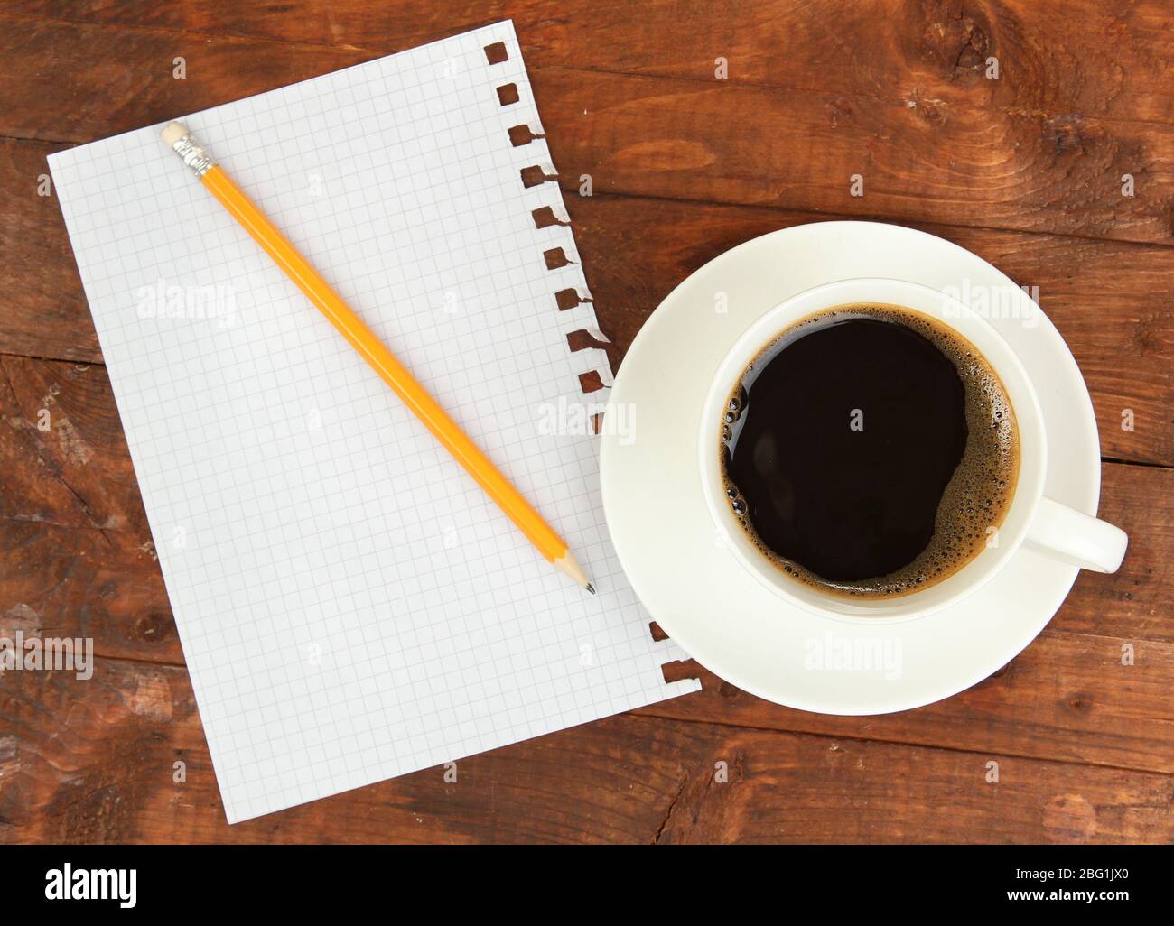Cup of coffee on worktable covered with documents close up Stock Photo