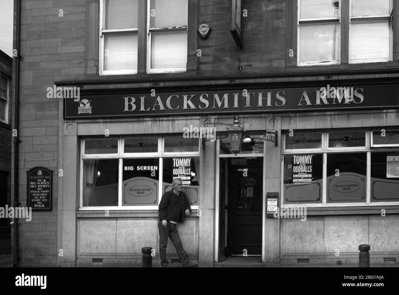 Waiting outside the Blacksmiths Arms, Gosforth High Street, Tyne and Wear Stock Photo