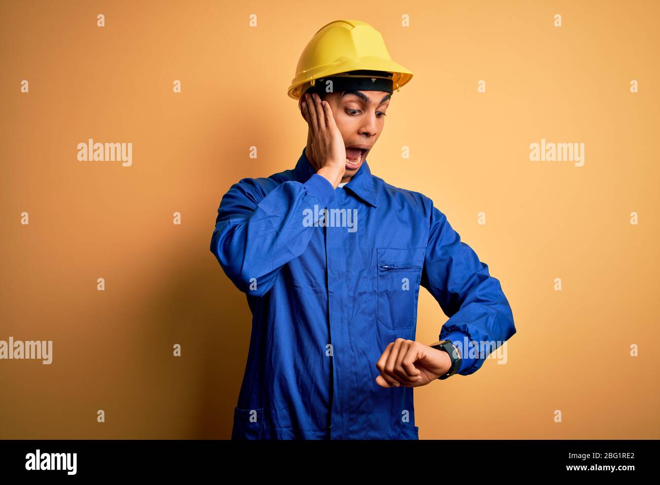 Young handsome african american worker man wearing blue uniform and ...