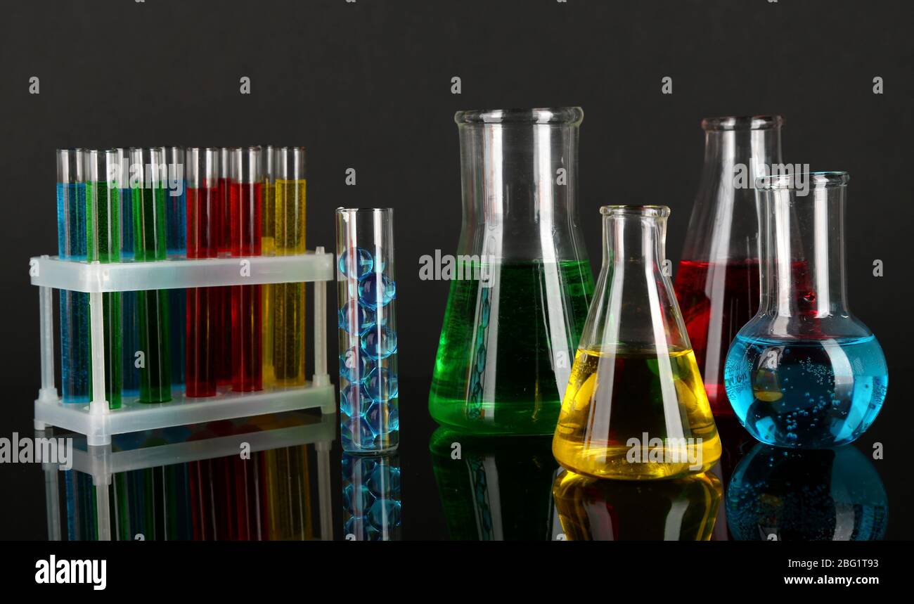 Test tubes with colorful liquids on dark grey background Stock Photo ...