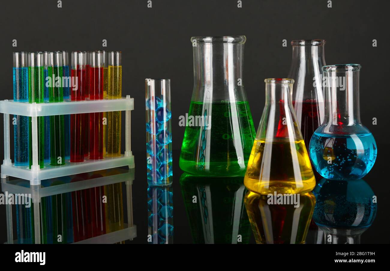 Test tubes with colorful liquids on dark grey background Stock Photo ...