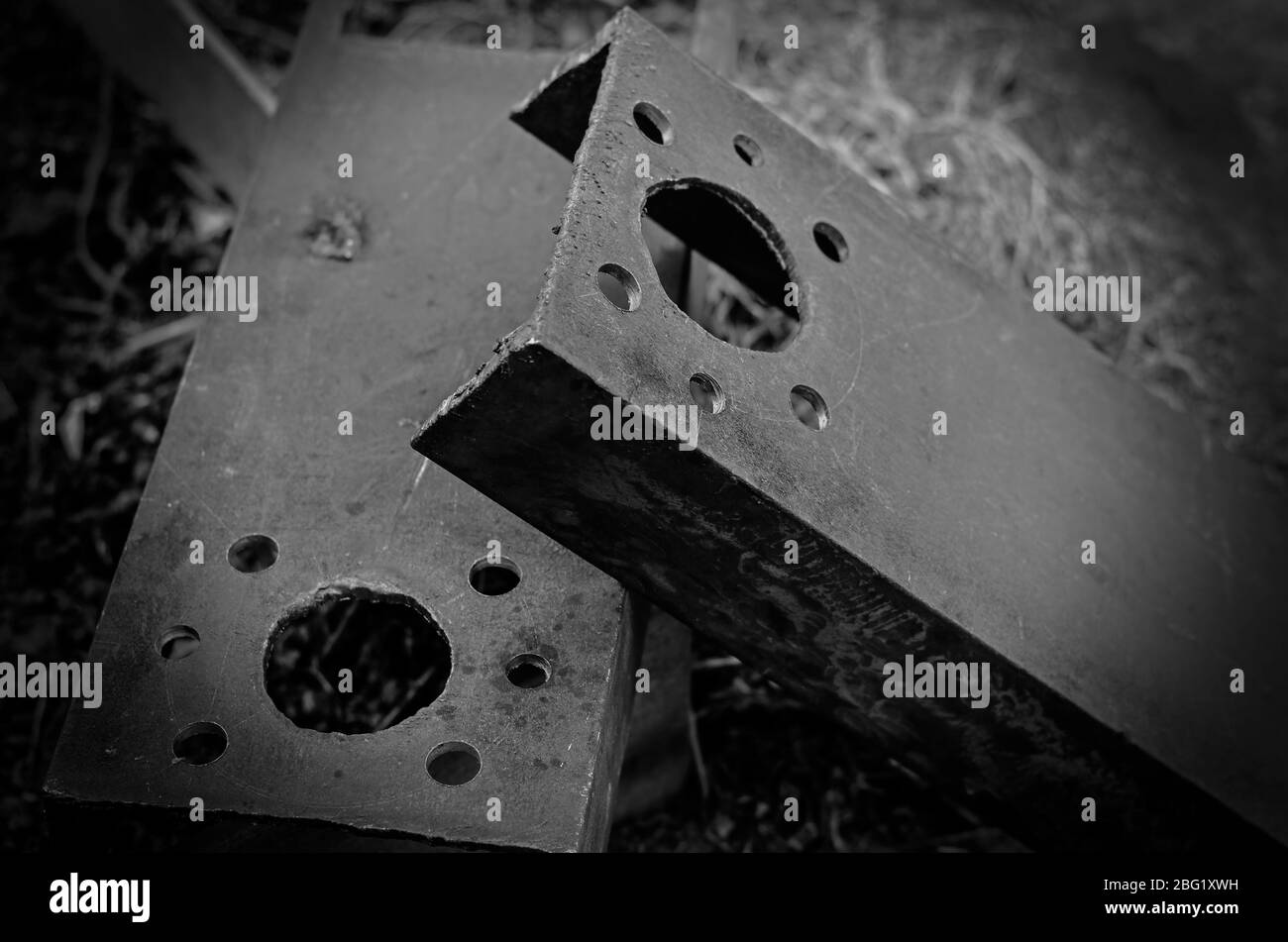 Drilled holes in metal channels. Two massive metal parts with seven structural holes in each. Industrial background. Close-up. Selective focus. Stock Photo