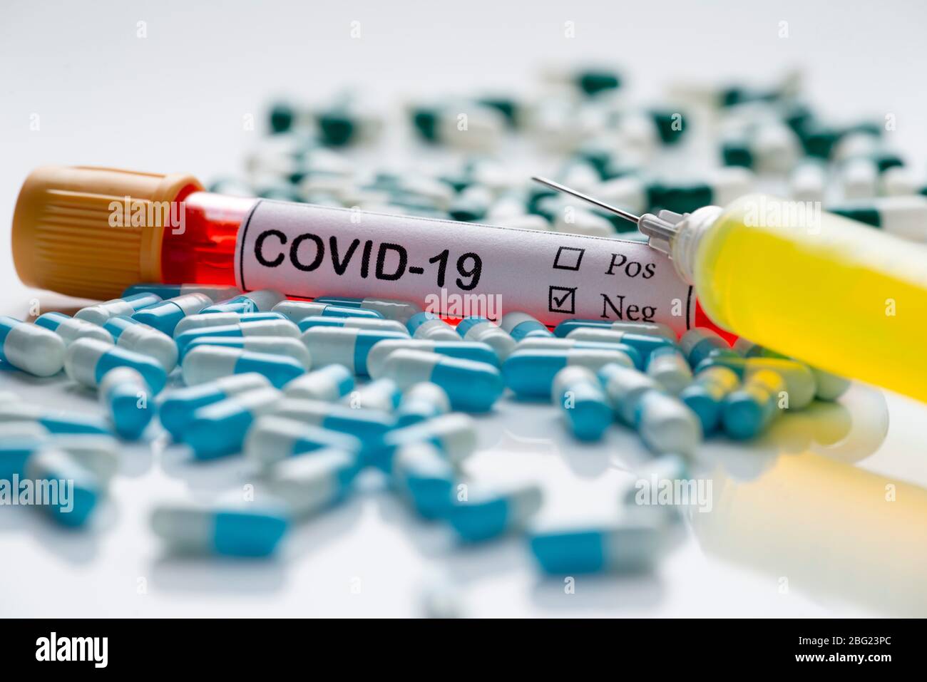 blood collection tube for clinical analysis, with covid-19 label, and capsules of medicine pills Stock Photo