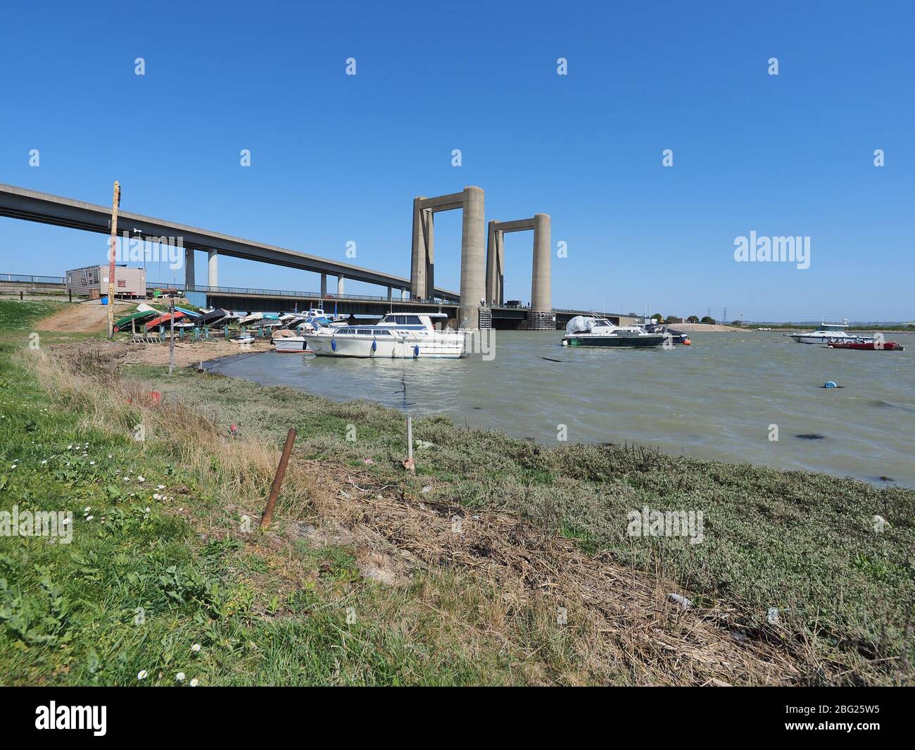Iwade, Kent, UK. 20th Apr, 2020. Today is the 60th anniversary of the distinctive Kingsferry Bridge, linking Isle of Sheppey with mainland Kent, being opened by the Duchess of Kent on 20 Apr, 1960. At the time it was the largest lifting bridge built in Britain since the Second World War. There is only one other similar design in the world based in Holland. In 2006, the infamous Sheppey Crossing was opened, but Kingsferry was retained for rail and road traffic. A generator is in situ for lifting the centre span as the power system needs a replacement part. Credit: James Bell/Alamy Live News Stock Photo