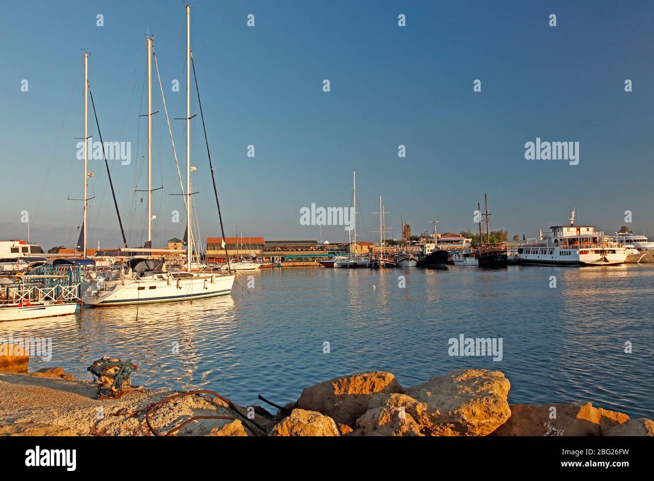 Boats moored at Paphos Harbour in early morning Stock Photo