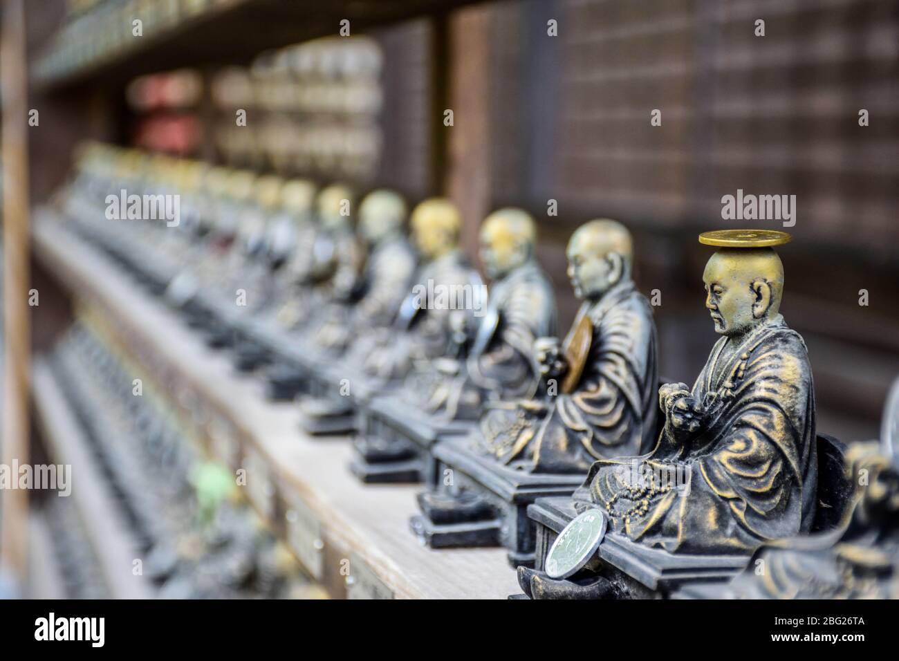 Small holy bronze statuettes in a shrine somewhere in Hiroshima prefecture in Japan Stock Photo