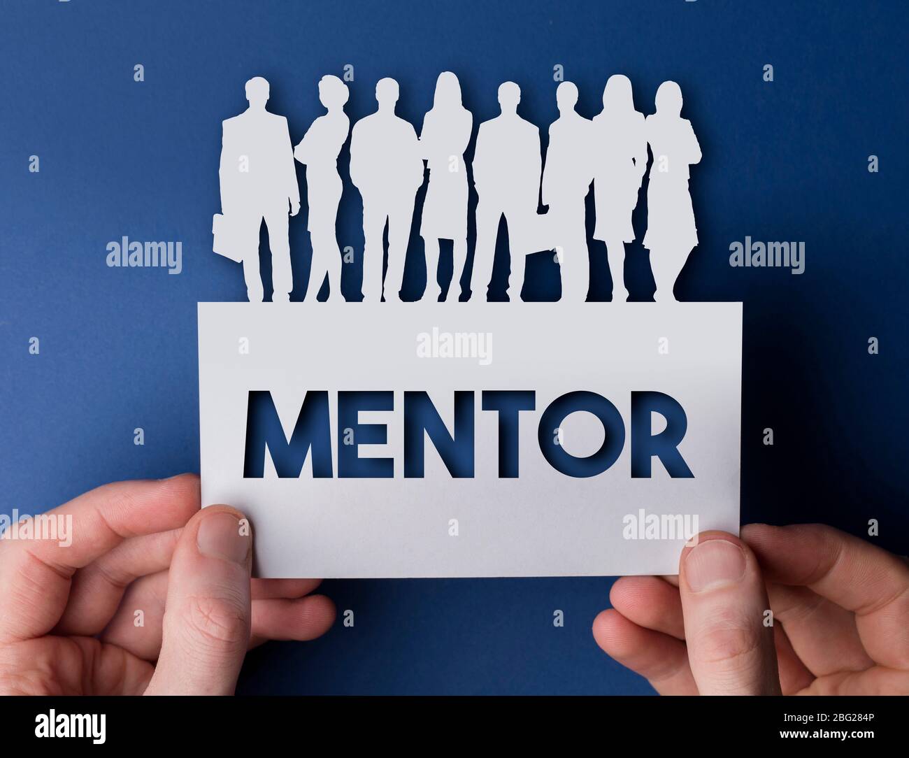 Hands holding a mentor white card business team people sign Stock Photo