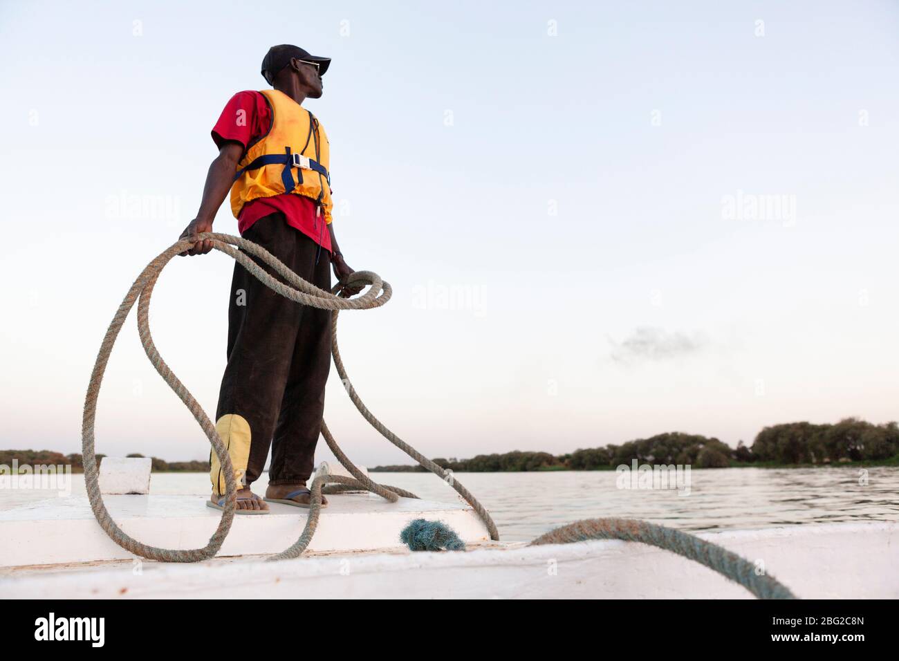 Bou el Mogdad crew member aboard the ship's passenger tender on the Senegal River. Stock Photo