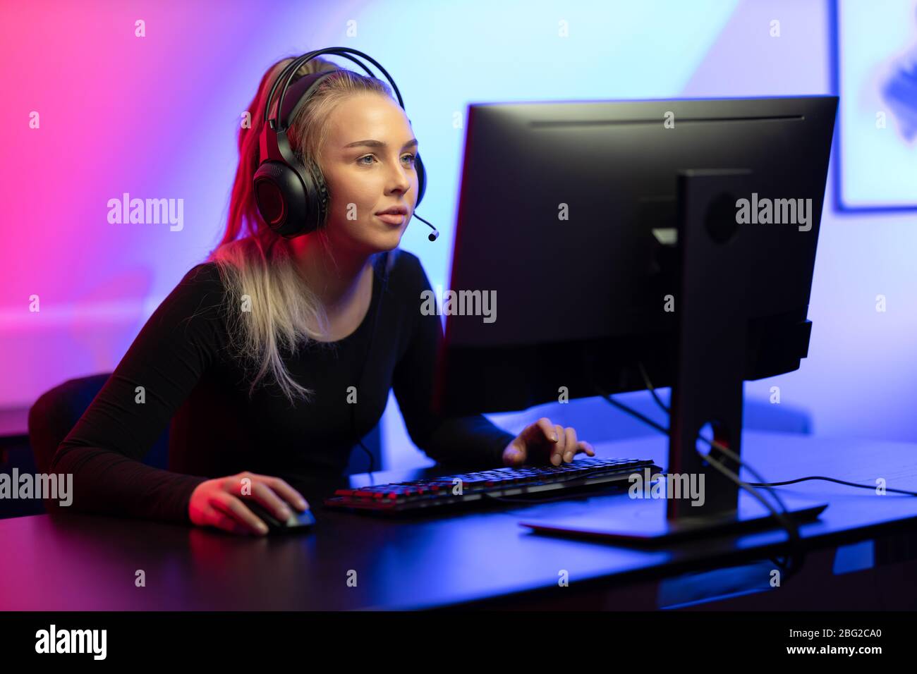 Happy Pretty Blonde Gamer Girl Playing Online Video Game on Her Personal  Computer Stock Photo - Alamy