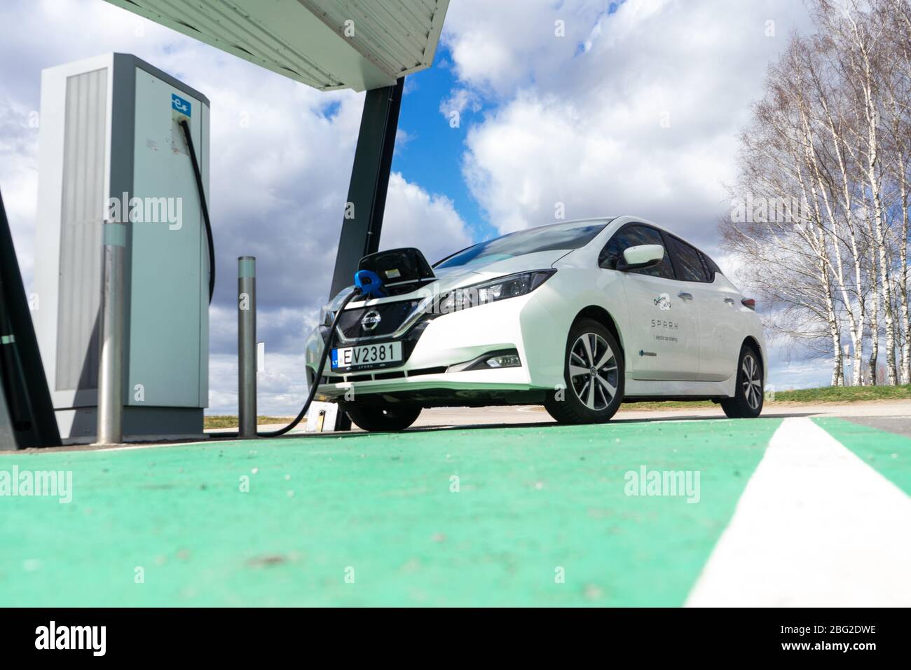 Electric car charging point with Nissan Leaf connected. EV parking and