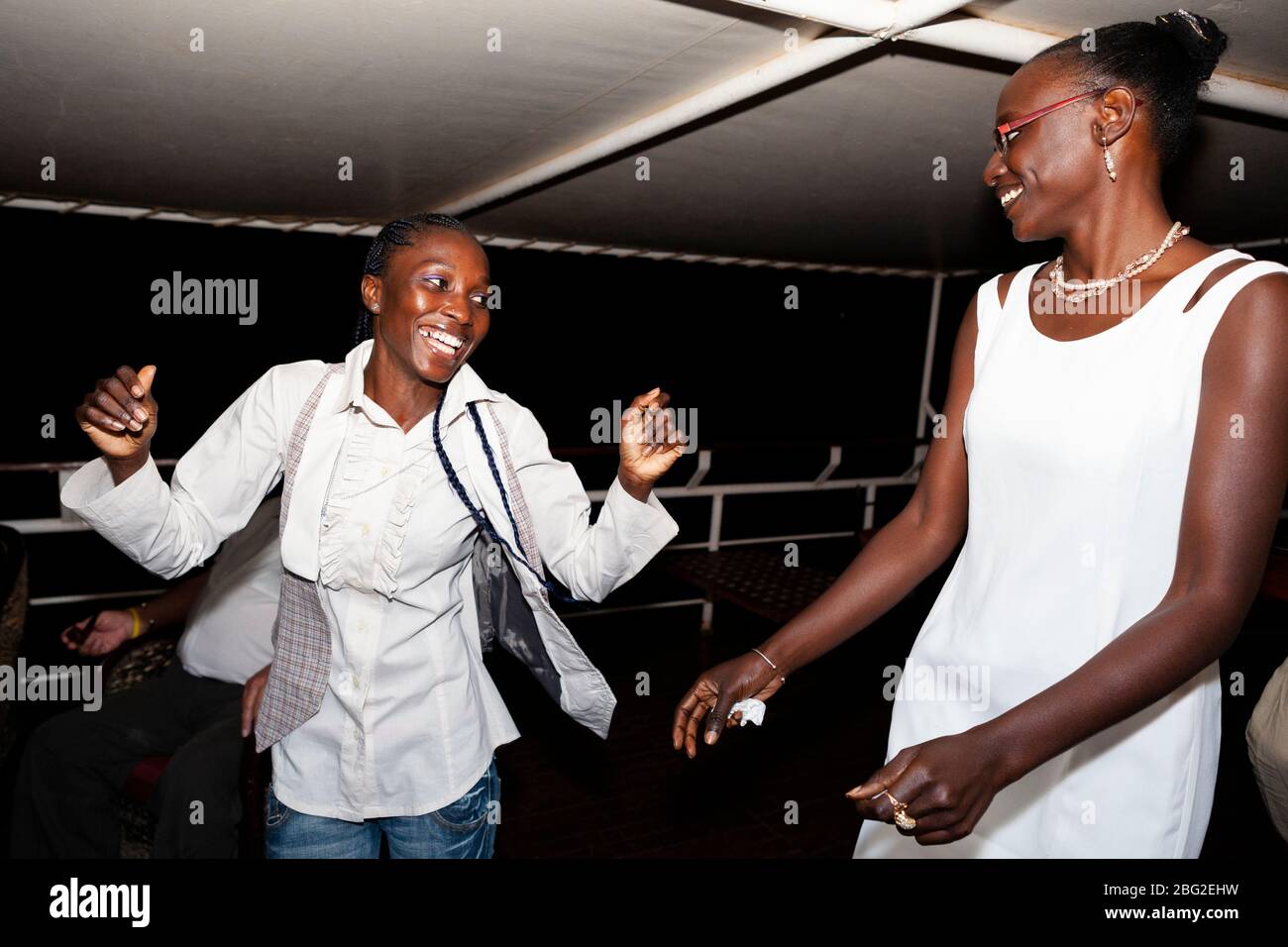 Dance party at the bar on the top deck of the Bou el Mogdad antique river boat on the Senegal River. Stock Photo