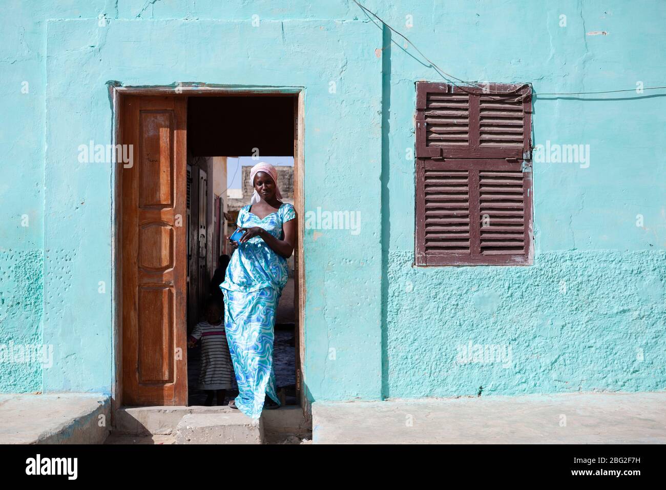 Senegalese lady in her doorway in Saint Louis, Senegal. Stock Photo